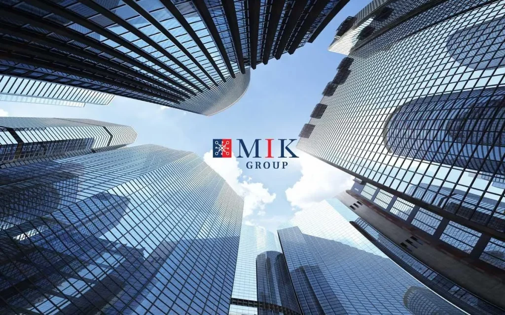 Logo MIK Group trên nền các tòa nhà cao tầng